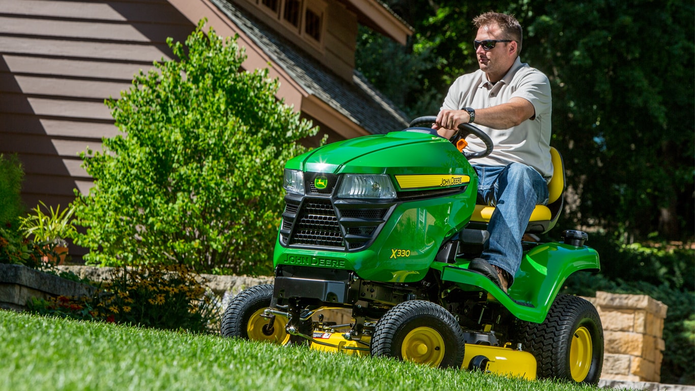 homeowner on tractor in lawn